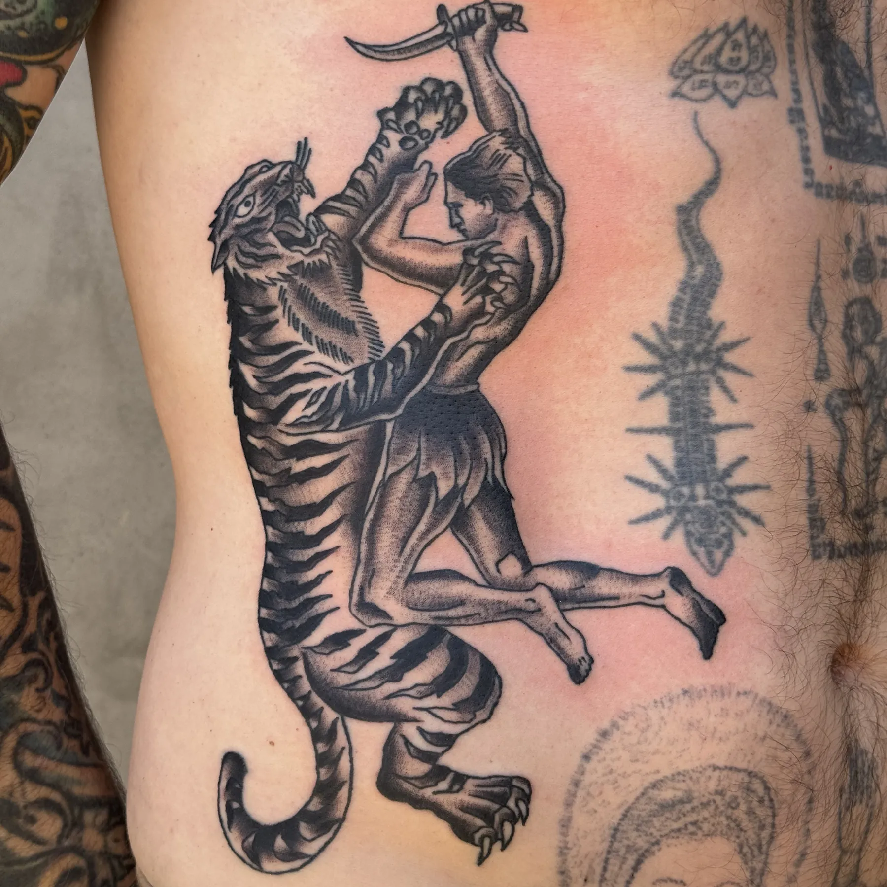Man fighting tiger traditional tattoo